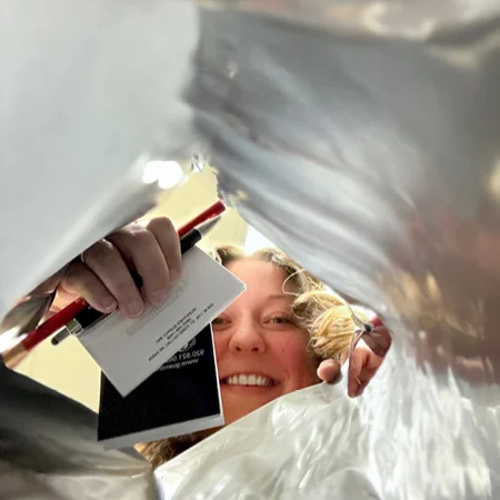 person looking in a bag of imprinted swag bag items