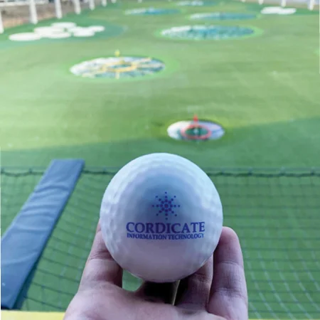 person holding a logoed golf ball