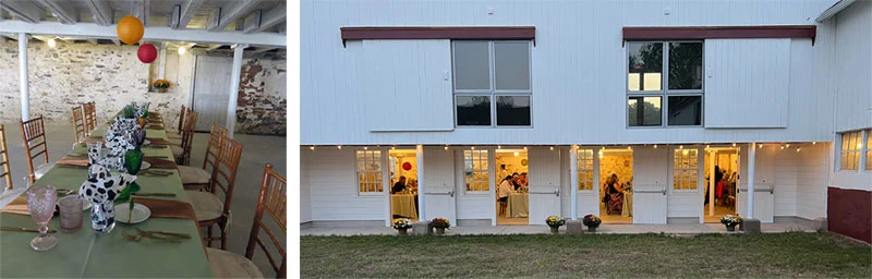 A barn with open doors during an event and tables inside the barn set up for an event
