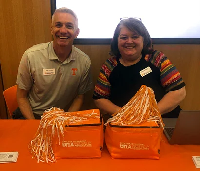 UTIA members with logoed coolers and pom poms