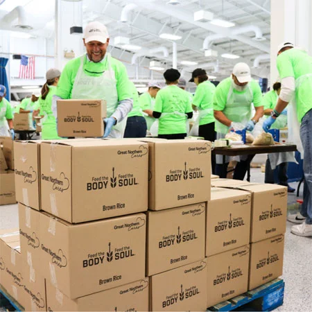 volunteer stacking boxes of donations