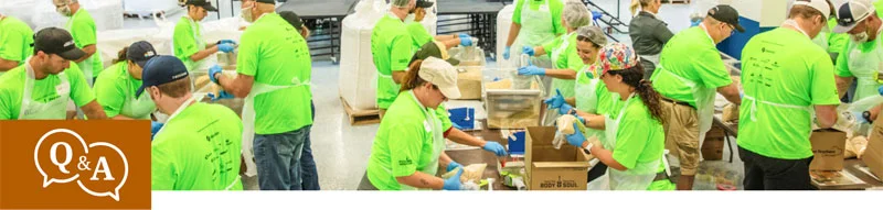 volunteers packing donated food into boxes
