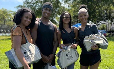 A group of people holding logoed bags
