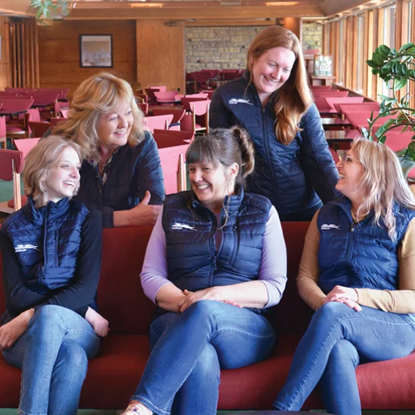 group of people wearing logoed insulated vests