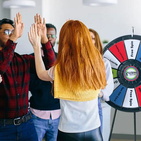 group of people with a spin wheel