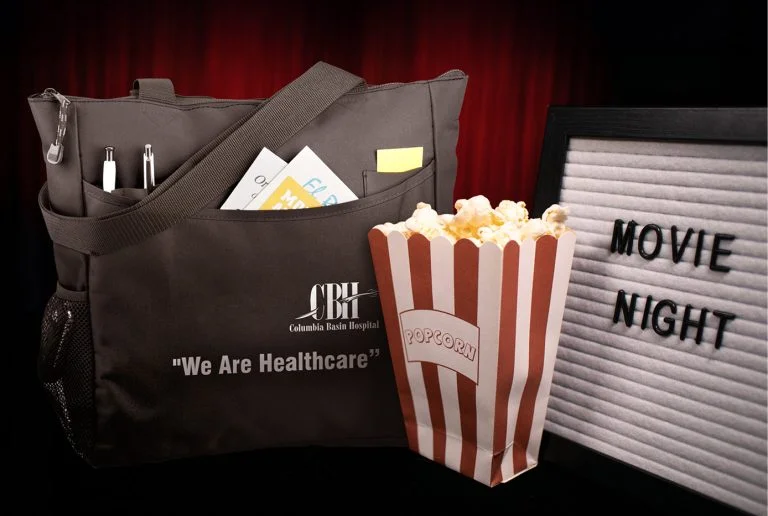 Movie night billboard with popcorn and team holiday gift bag