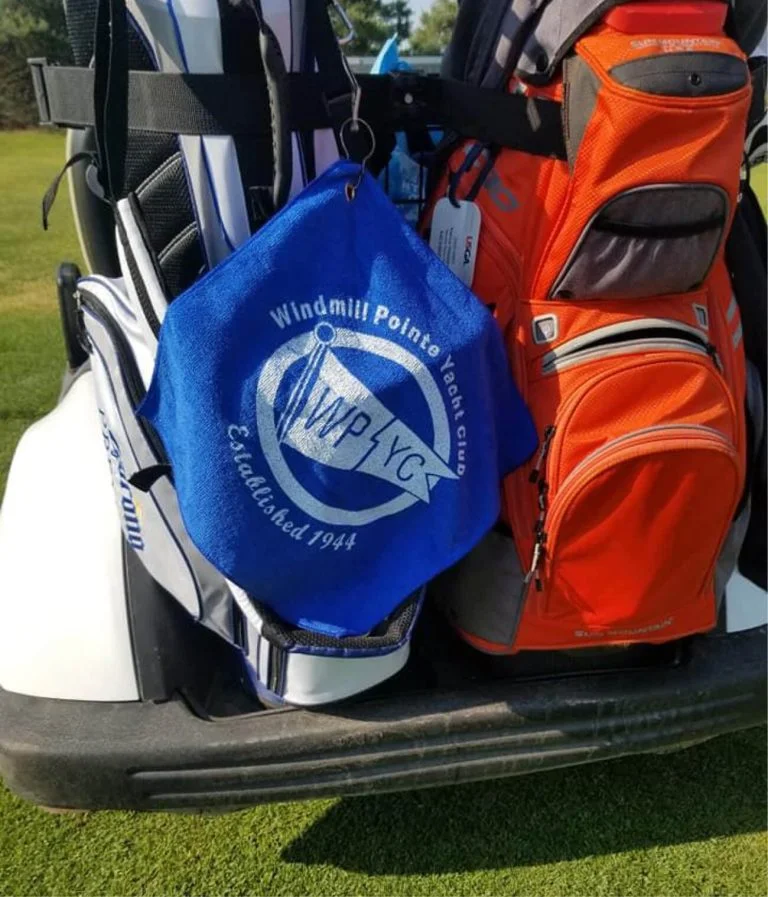 Blue branded golf towel on the back of a golf cart.