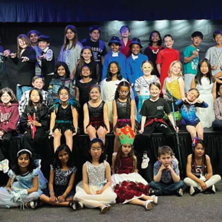 Talent show students wear drama outfits as they pose for the camera