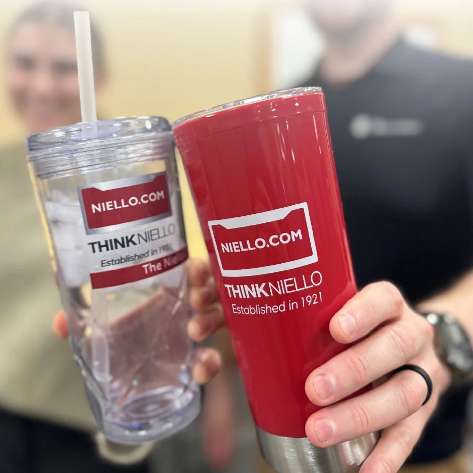 two people holding custom logoed drinkware