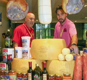 Two Ace Endico employees next to the product at their trade show booth