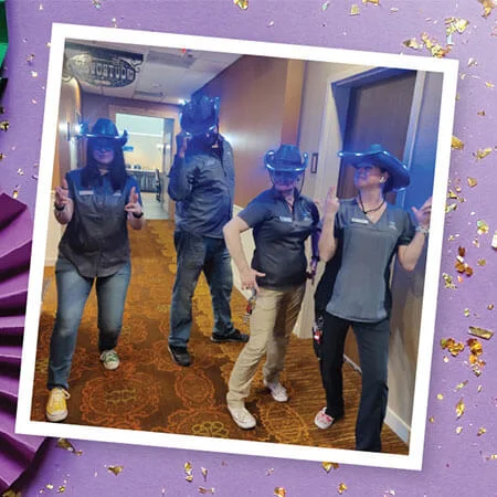 Light-up cowboy hats on team members