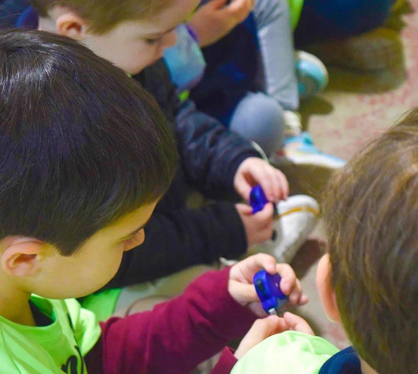 group of children holding logoes tape measures