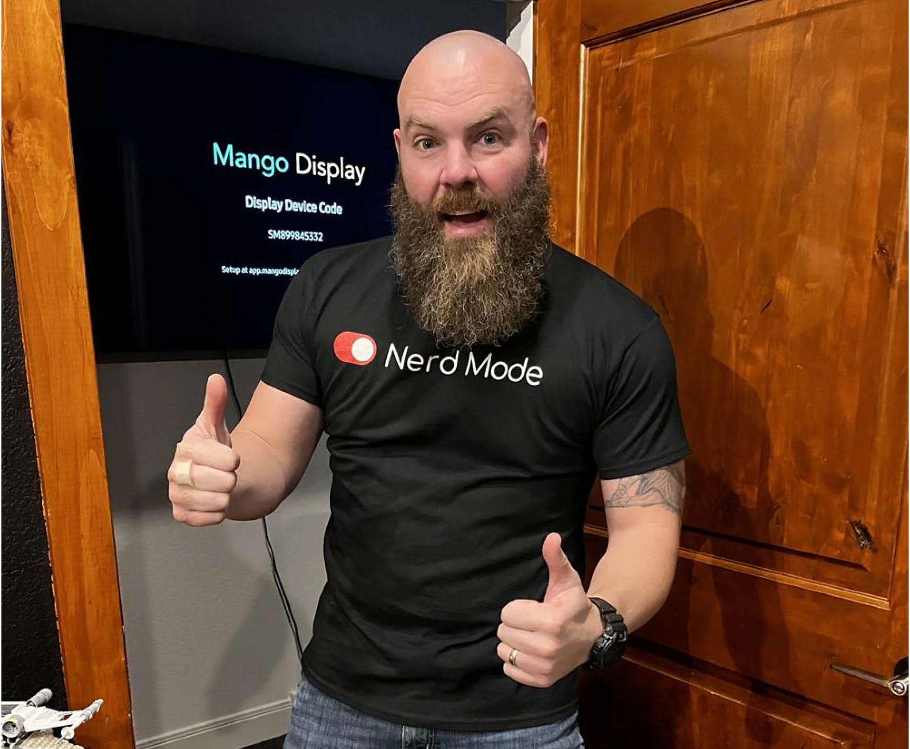 person wearing a t shirt giving a thumbs up