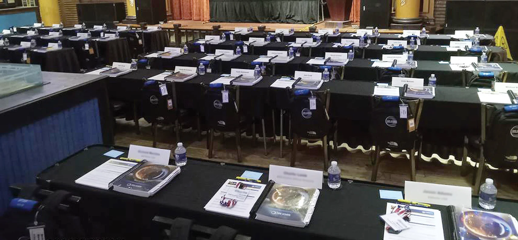 tables with logoed bottled water and training materials