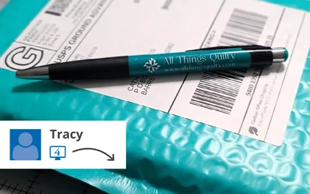 Branded promotional pen sitting on top of mailing package