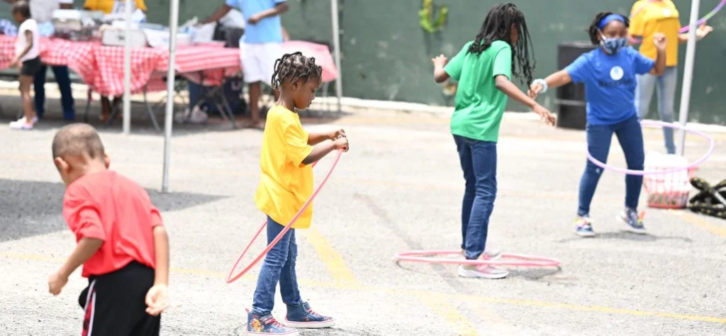 four kids participating in fun hula hoop competition