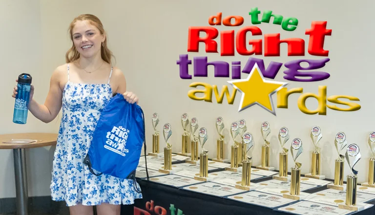 person holding up a water bottle and trophy at an awards ceremony