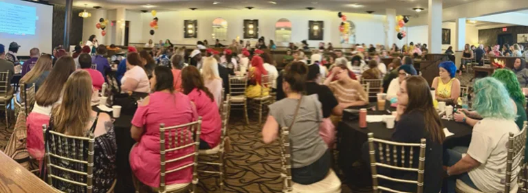 employees sitting at tables during a staff gathering