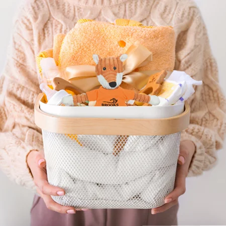 A person holding a basket of baby items
