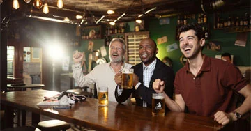 group of people with custom pint glasses