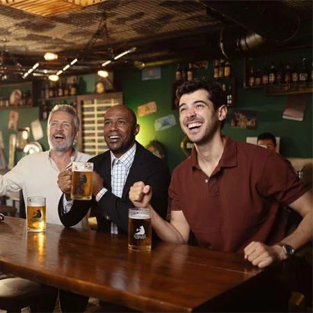group of people with custom pint glasses