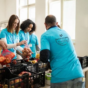 group of people volunteering while wearing branded t-shirts