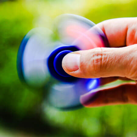 Person Playing Blue Hand Spinner