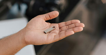 Man showing USB stick on hand