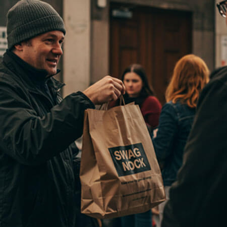 A person holding a brown bag