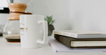 White Mug Near Book