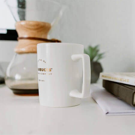 White Mug Near Book