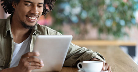 Man reading on an electronic device.