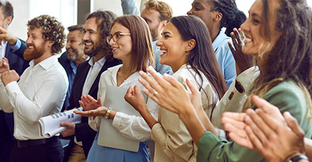 Group of people clapping their hands.