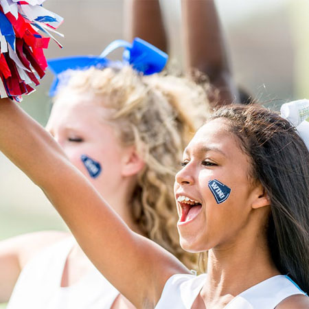 cheerleaders cheering with pom poms