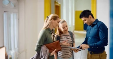 two teachers touching elbows