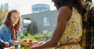 two people holding produce