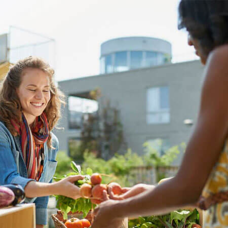 two people holding produce