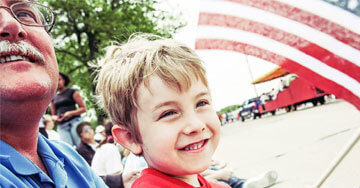 two people smiling at a parade