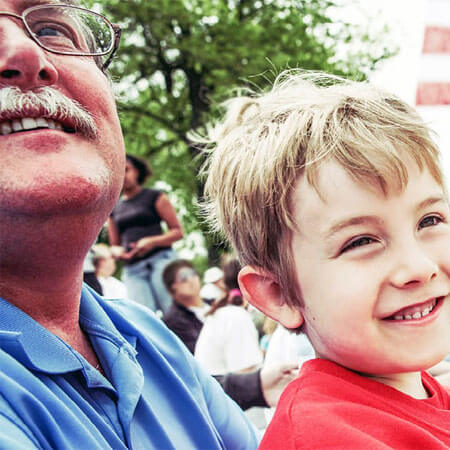 two people smiling at a parade