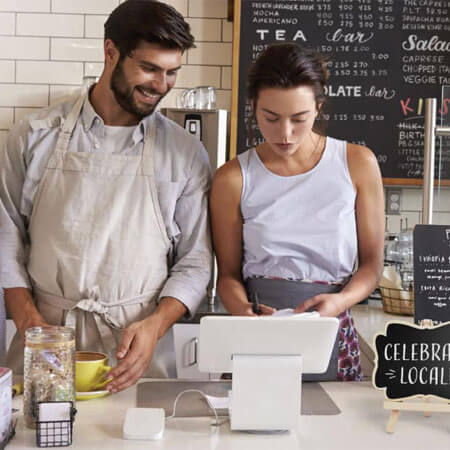 two people working behind a business counter