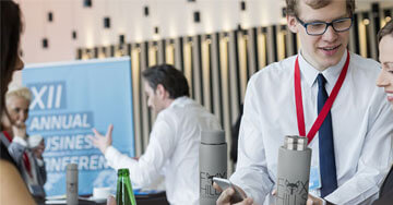 two people talking next to imprinted bottles