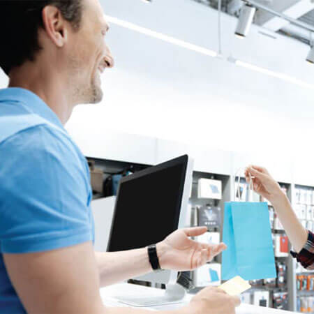 customer at a checkout counter holding a bag