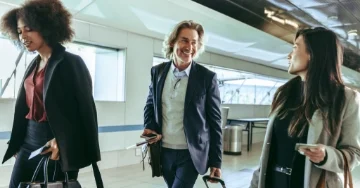 Two business travelers at the airport walking to their destination.