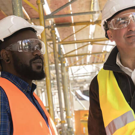 two people in safety vests talking