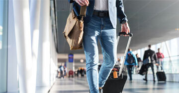 person pulling a piece of luggage