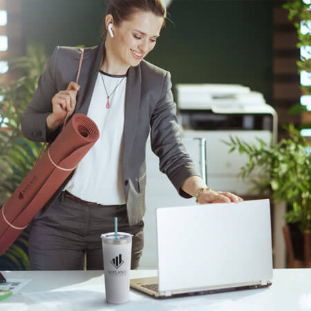 person carrying a yoga mat looking at a computer