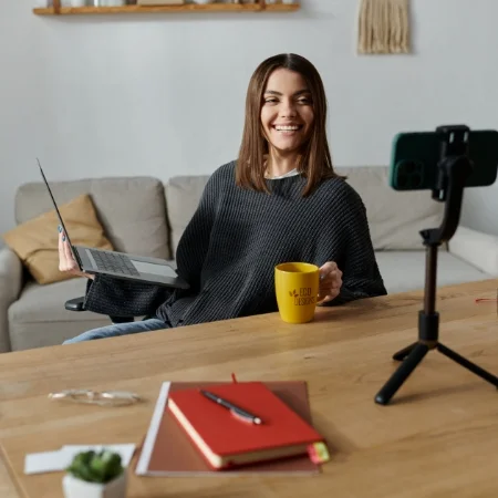 Smiling influencer taking a picture with a sponsored product.