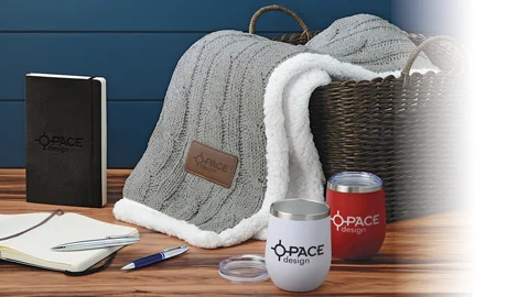 Business Gifts that include a blanket, notebooks, pens and tumblers