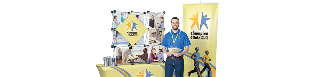 Promotional trade show items that include a vertical banner, display and table throw