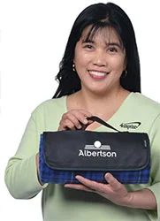 4imprint employee Felma holding a rolled up Crossland Picnic Blanket